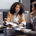 African-American travel agent working with client