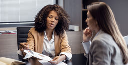 African-American travel agent working with client