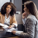 African-American travel agent working with client