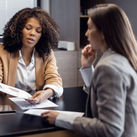 African-American travel agent working with client