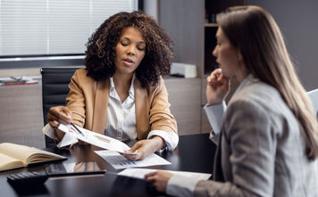 African-American travel agent working with client