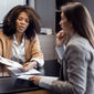 African-American travel agent working with client