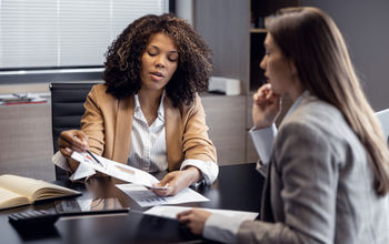African-American travel agent working with client