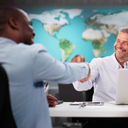 Clients interacting with a travel advisor at an agency office.