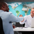 Clients interacting with a travel advisor at an agency office.