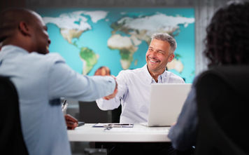 Clients interacting with a travel advisor at an agency office.