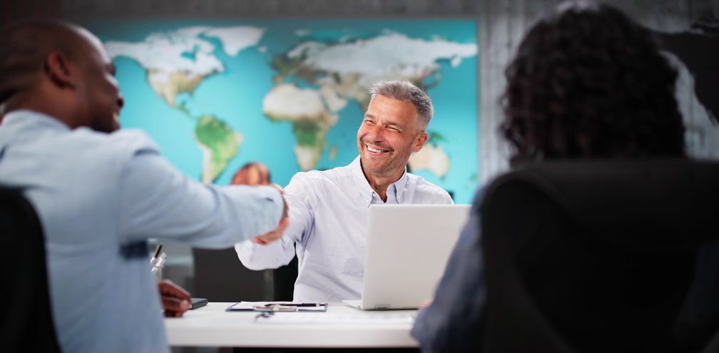 Clients interacting with a travel advisor at an agency office.