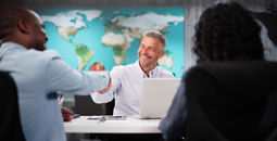 Clients interacting with a travel advisor at an agency office.