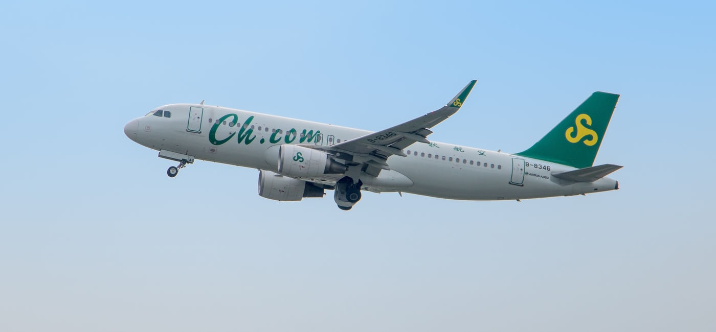 Image: Spring Airlines plane in flight. (Photo Credit: milkovasa/Adobe)