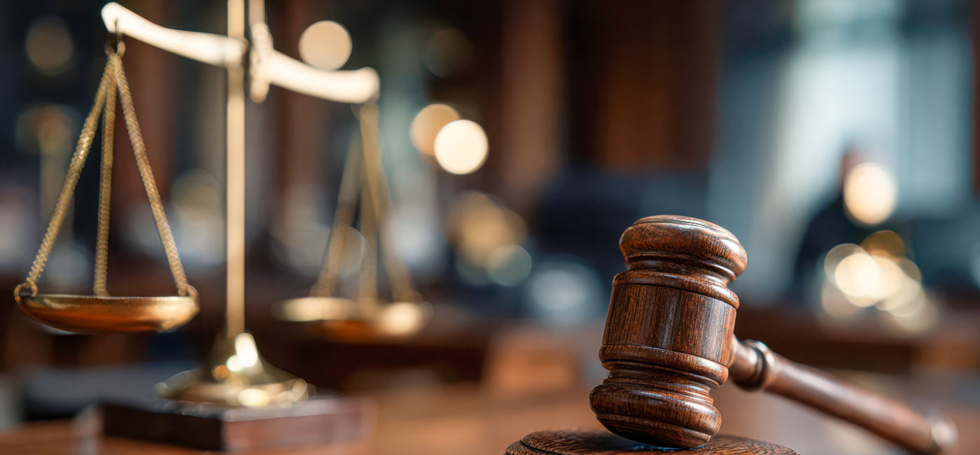 Image: Gavel and scales displayed in a courtroom during legal proceedings (Photo Credit: Adobe Stock)