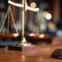 Gavel and scales displayed in a courtroom during legal proceedings