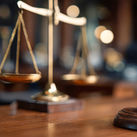 Gavel and scales displayed in a courtroom during legal proceedings