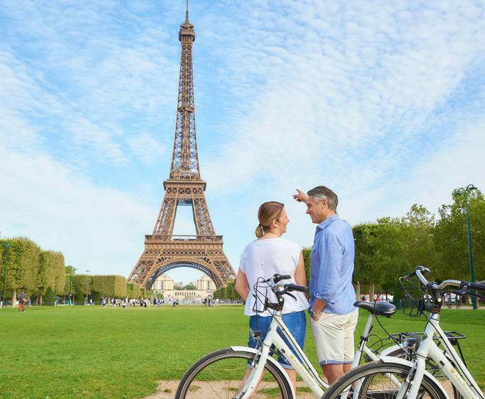 A couple biking on the Seine River.