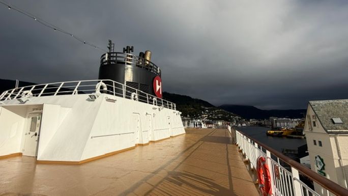 Dramatic Norwegian sky frames the open deck aboard Hurtigruten’s MS Trollsfjord.