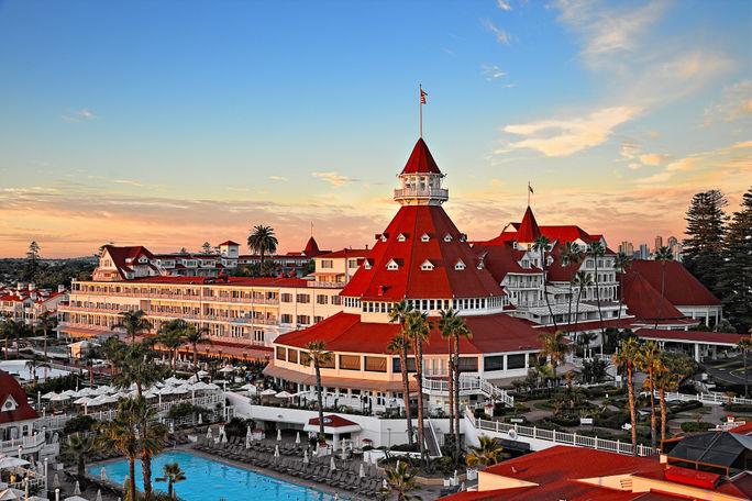 Hotel del Coronado Exterior view of victorian hotel with red roof and swimming pool
