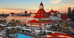Exterior view of victorian hotel with red roof and swimming pool
