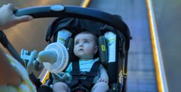 Battery-powered fan attached to a stroller walking through the airport