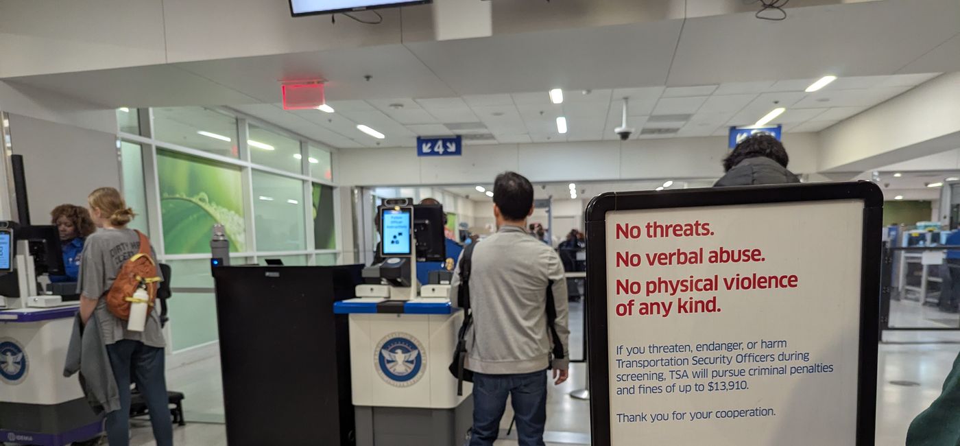 Image: A sign warning air travelers not to threaten or harm TSA officers (Photo Credit: Eric Bowman)