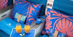 Image of seats, drinks, and headphones in Air Tahiti Nui Manava Premium class