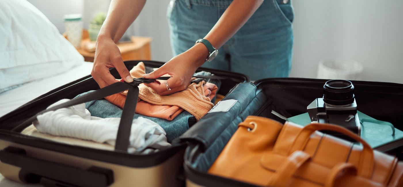 Image: A traveller packs a suitcase (Photo Credit: Adobe)