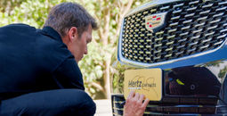 Tom Brady signs Hertz car.