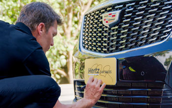 Tom Brady signs Hertz car.