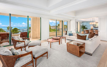 Hotel suite with white and grey furnishings and expansive ocean view