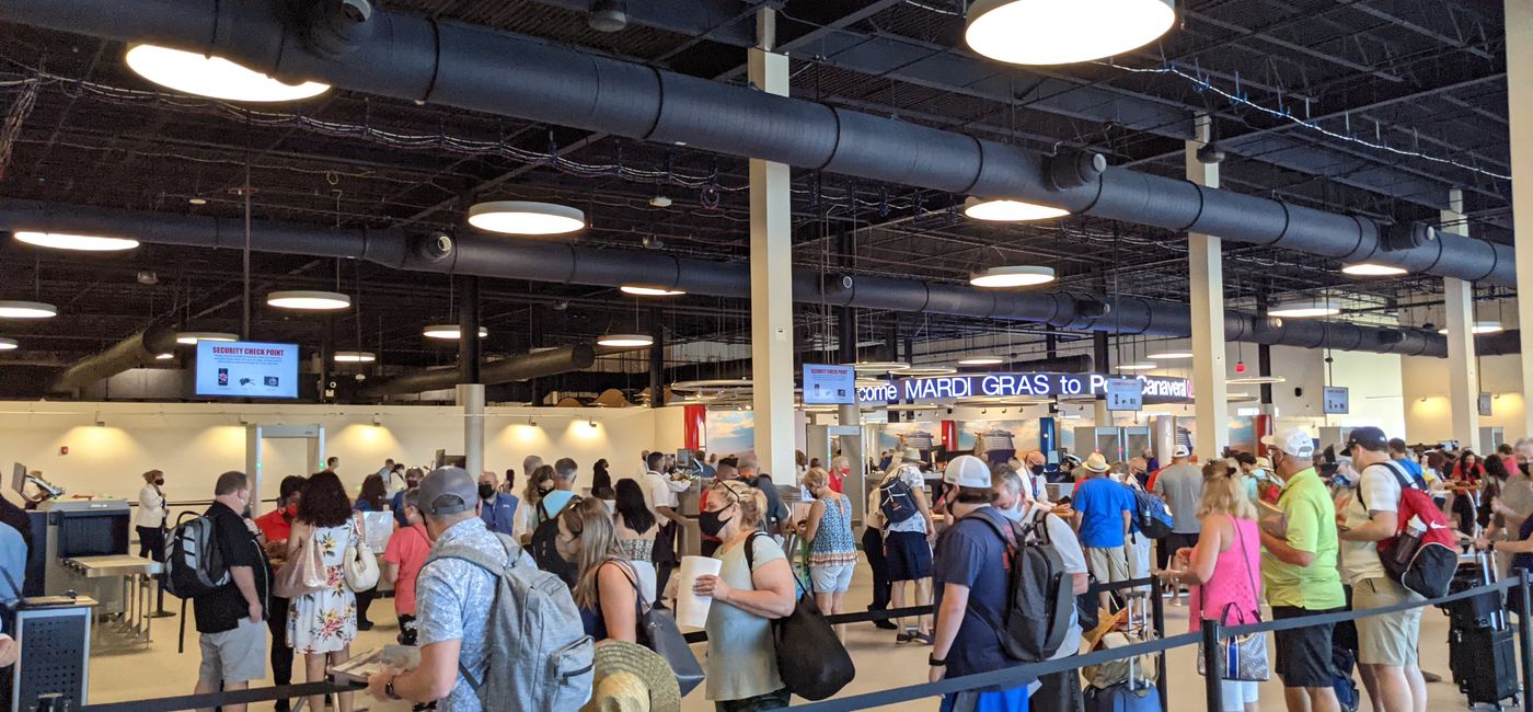 Image: Travelers wait to board Carnival Mardi Gras at Terminal 3 at Port Canaveral. (photo via Eric Bowman)