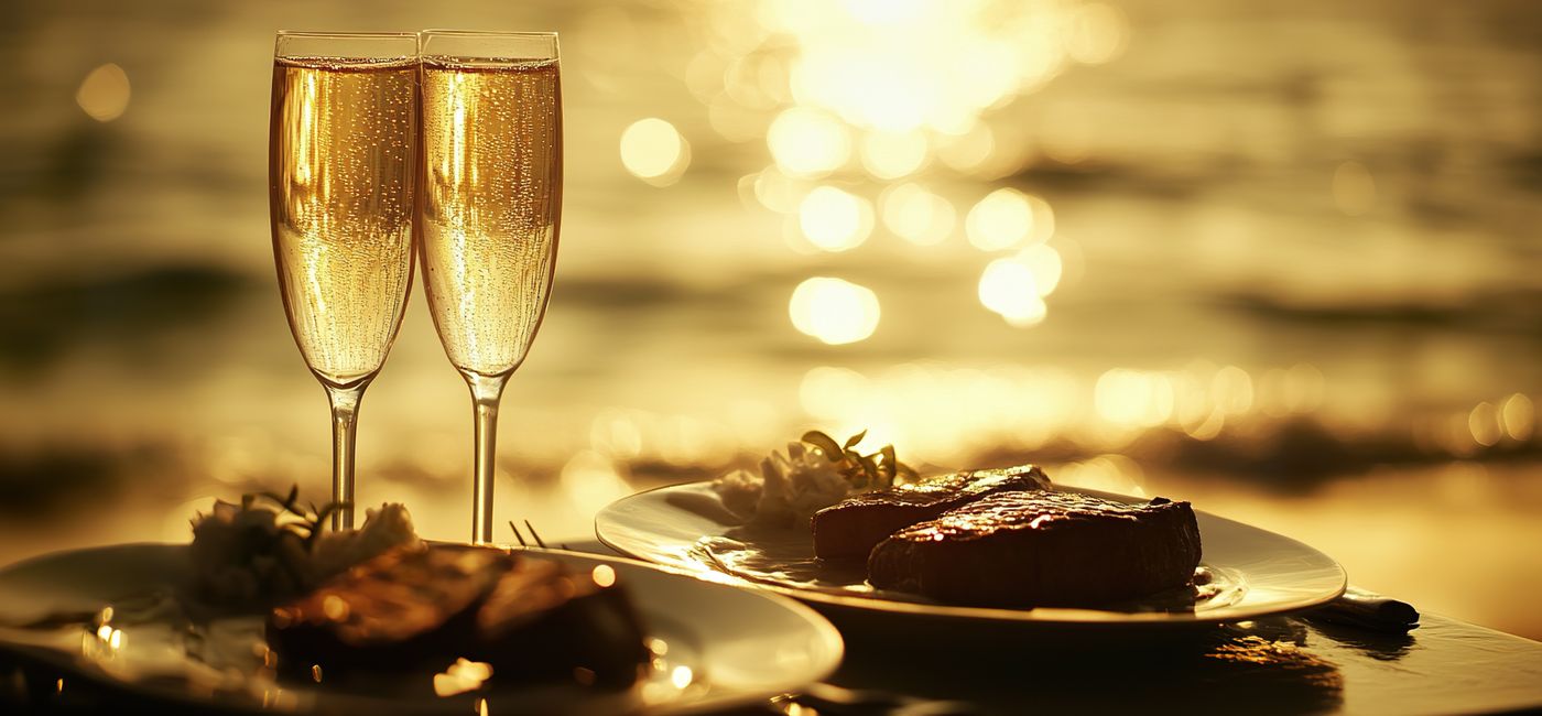 Image: Champagne and fine dining on the beach (Photo Credit: Adobe Stock / inthasone / Generated with AI)