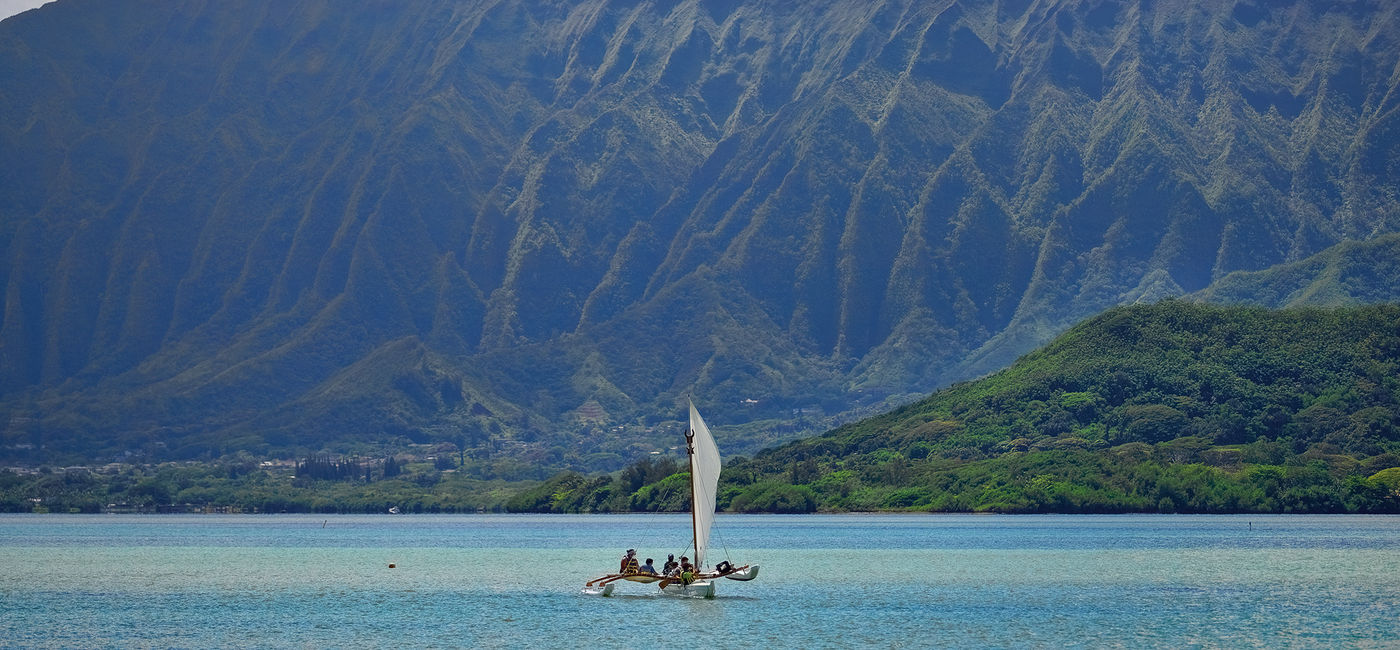 Image: Outrigger canoe sailing in Kaneohe Bay, Oahu, Hawaii. (Photo Credit: Adobe Stock/ottosphotos)