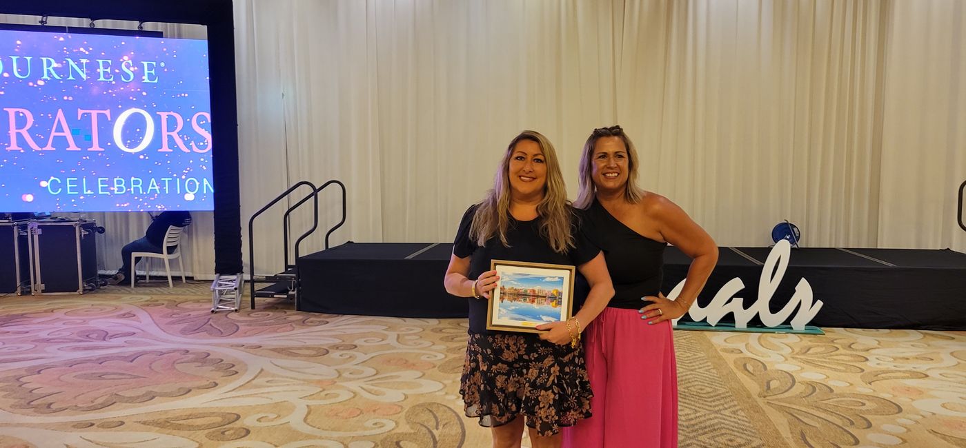 Image: Working smarter and faster is the key to more sales and more success.” – Alicia Kingston (left) is presented with her Journese Curator award by Denise DeCoite, Journese’s supervisor, destination specialists. (Photo by Brian Major)