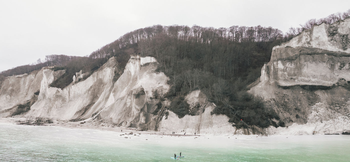 Image: Travelers paddleboard around the Danish island of Mon. (Photo Credit: Mads Tolstrup)