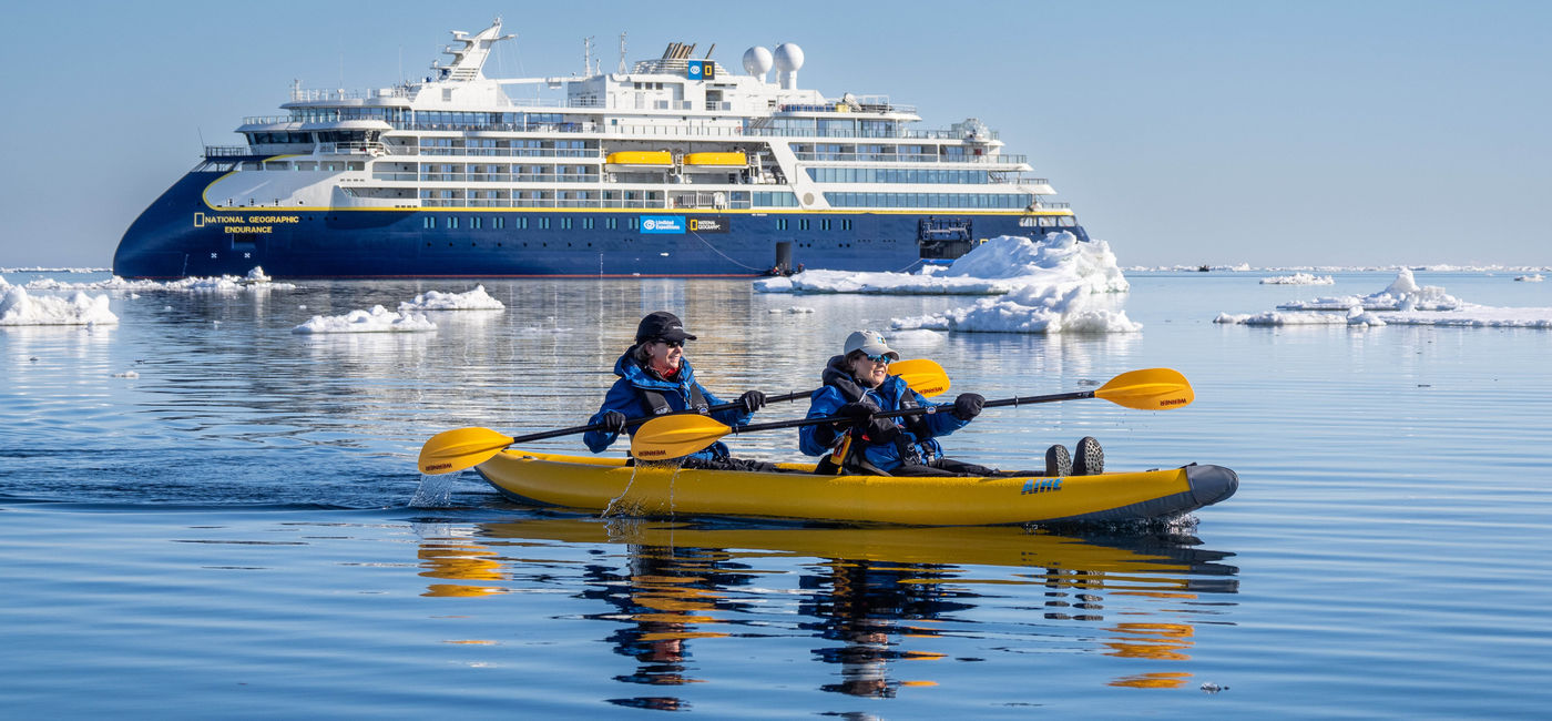 Image: Two travelers kayak in the sea along Svalbard, Norway, with National Geographic-Lindblad Expeditions. (Photo Credit: Michael S. Nolan)