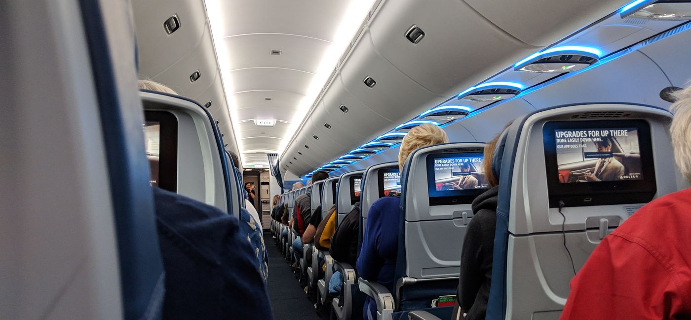 Image: Passengers seated on an airplane. (photo by Eric Bowman)