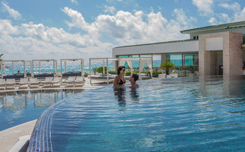 Couple enjoying the pool at Sandos Cancun