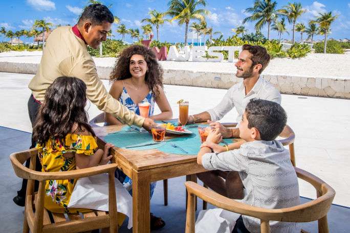 A family enjoys launch at Mar House at Majestic Elegance Costa Mujeres.