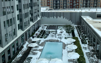 Hotel courtyard covered in snow with frozen swimming pool