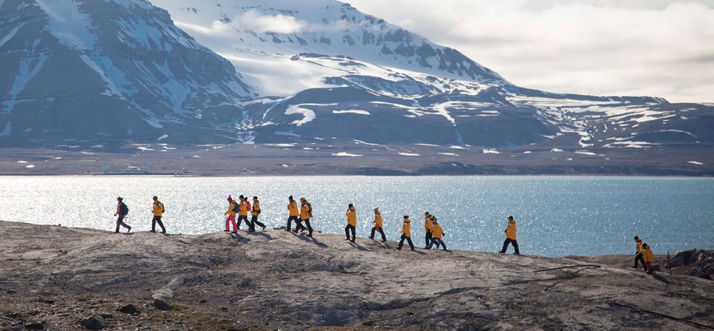 Image: A Quark Expeditions group hike along a coastline. (photo via Quark Expeditions) (Photo Credit: (photo via Quark Expeditions))