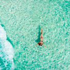 Woman floating in the Caribbean Sea in Cancun, Mexico