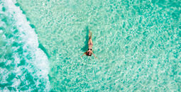 Woman floating in the Caribbean Sea in Cancun, Mexico