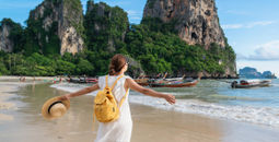 Young female traveler enjoying a summer vacation on a tropical beach in Krabi, Thailand.