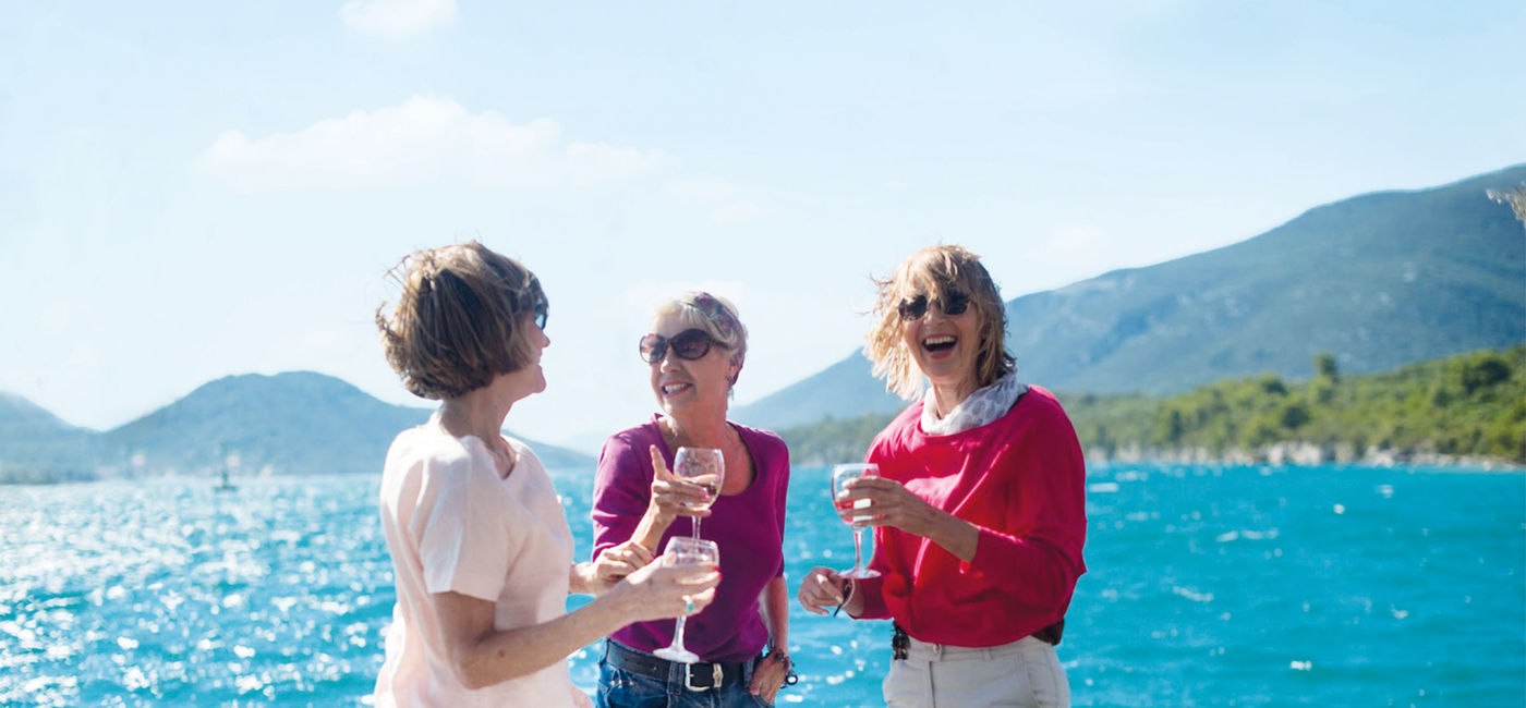 Image: Women sipping wine and eating fresh oysters on the Croatian coast (photo via Insight Vacations) (Photo Credit: (photo via Insight Vacations))