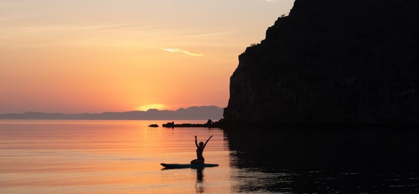 Image: A paddleboarder rejoices in the beauty of the sunset in Loreto, Baja California.