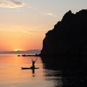 A paddleboarder rejoices in the beauty of the sunset in Loreto, Baja California.