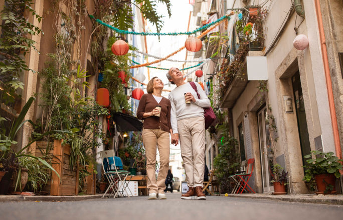 An elderly couple explores a new city. Adobe Stock, elderly travelers, elderly couple, couples travel, europe travel, retirement travel, boomer travel