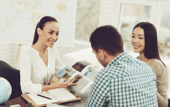 Young couple speaking to a travel advisor