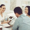 Young couple speaking to a travel advisor