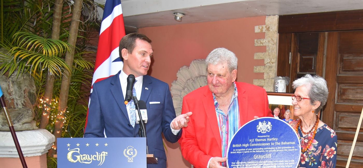 Image: AnnaMaria and Enrico Garzaroli accept the British Blue Plaque from British High Commissioner Thomas Hartley. (Photo Credit: Graycliff Hotel and Restaurant)