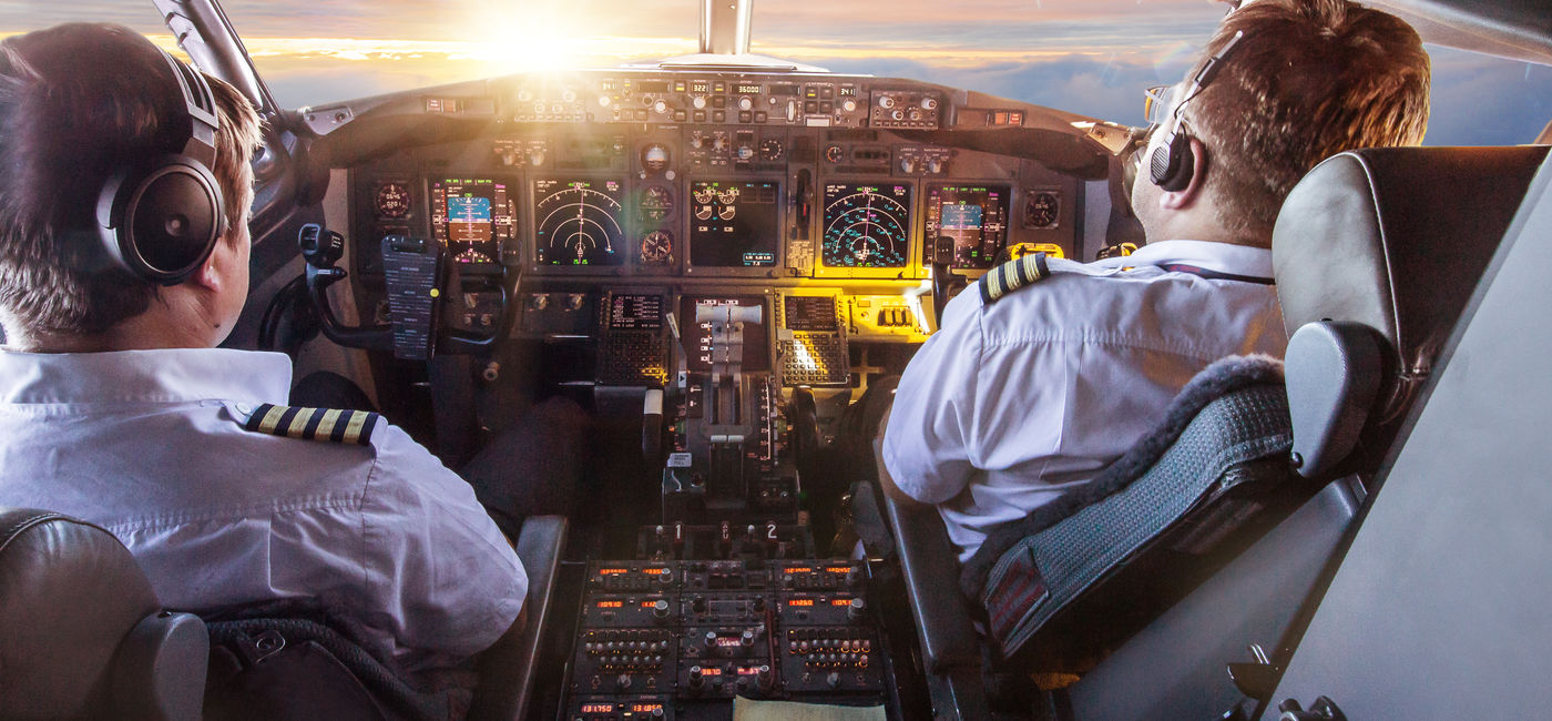 Image: Pilots in the cockpit during a flight with commercial airplane. (Photo Credit: Lukas Gojda / Adobe Stock)