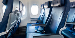 Rows of economy class airplane seating.
